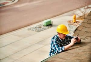 Home Appraiser or Home Inspector surveying roof of property